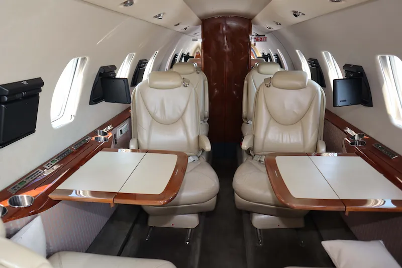 Spacious midsize cabin layout featuring a dropped aisle and executive club leather seating inside a Cessna Citation XLS private jet