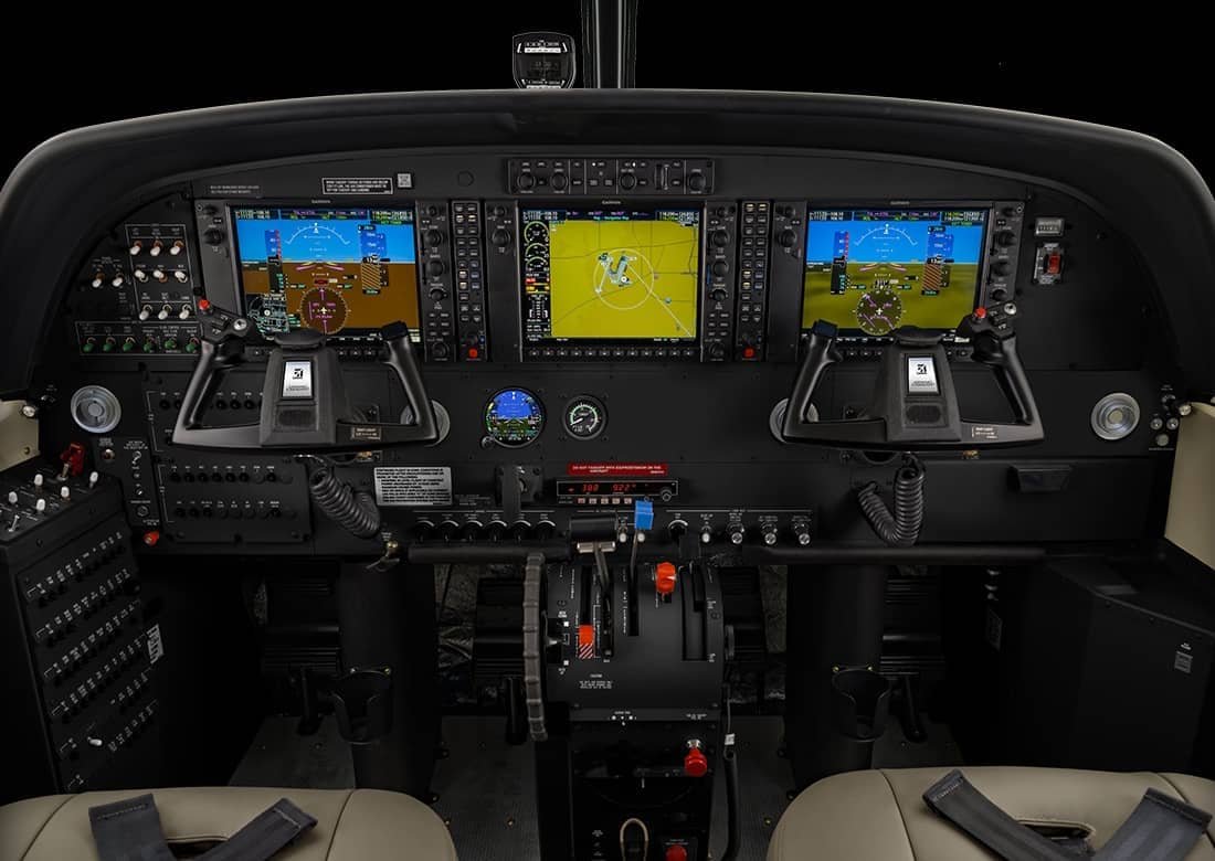 Modern flight deck instrument panel and pilot controls inside a Cessna Grand Caravan EX private aircraft