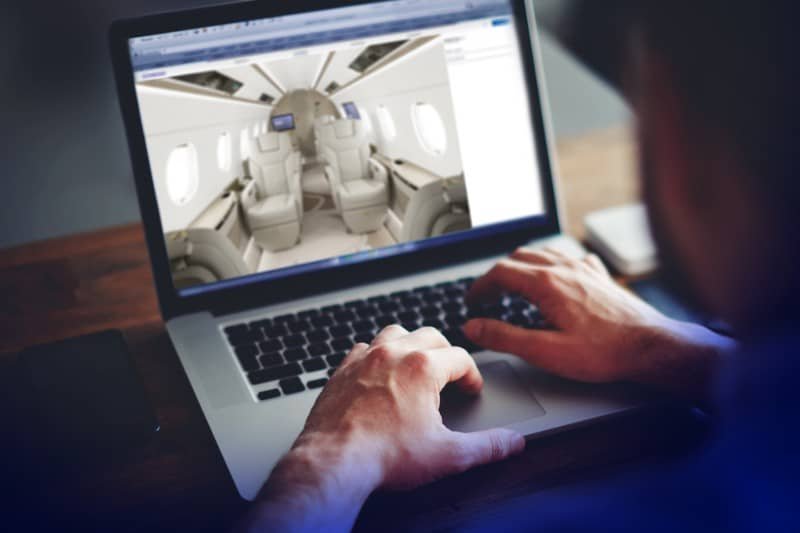 Executive workspace with premium internet connectivity and charging ports inside an Embraer Praetor 500 cabin